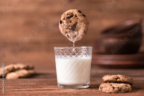  Cookie falls into the glass of milk. 