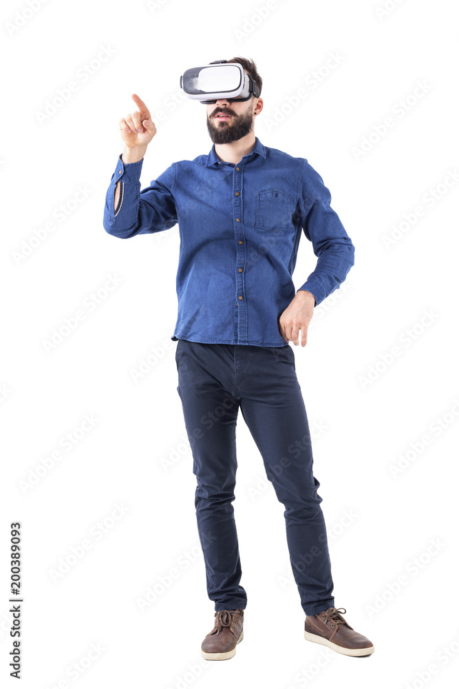 Young adult businessman wearing vr glasses interacting with touch screen using finger. Full body isolated on white background. Young adult businessman wearing vr glasses interacting with touch screen using finger. Full body isolated on white background.