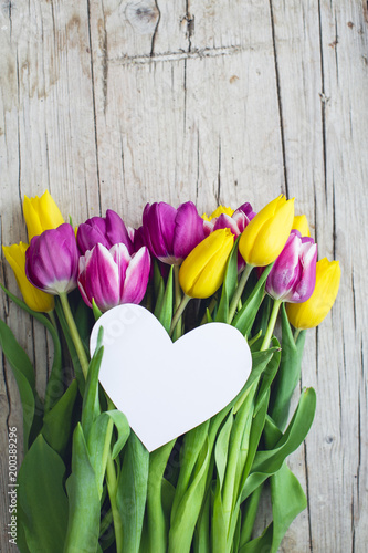 Fototapeta Naklejka Na Ścianę i Meble -  Greeting card - Pink and yellow tulips on a wooden background