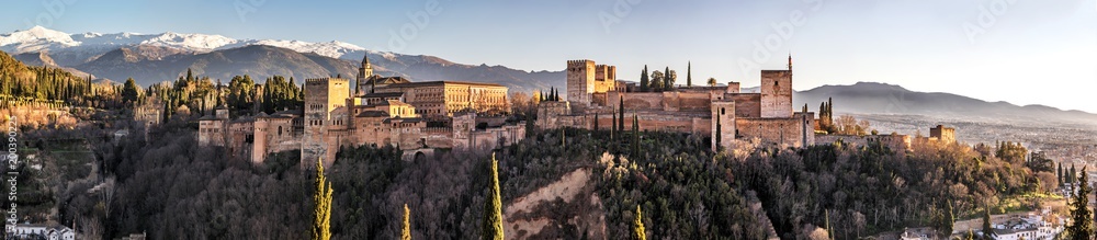 Palace and fortress complex Alhambra with Comares Tower, Palacios Nazaries and Palace of Charles V during sunset in Granada, Andalusia, Spain.