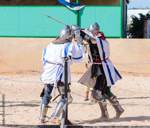 Two knights - participants in the knight festival are fighting on the lists in Goren park in Israel photo