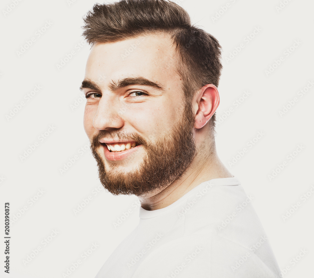 Obraz premium Lifestyle and people concept: Closeup portrait of a happy young man smiling on white background