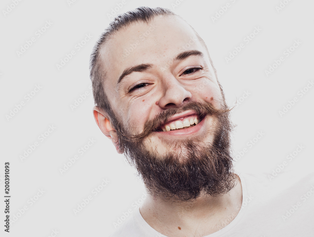 Obraz premium Lifestyle and people concept: Closeup portrait of a happy young man smiling on white background
