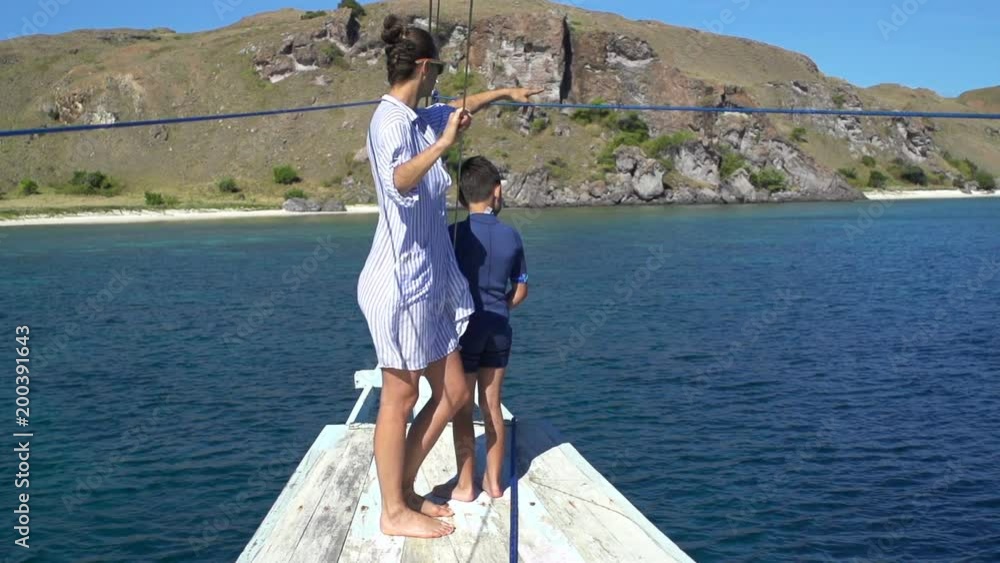 Mother and son admire view while sailing yacht on sea, super slow motion 120fps
Mother and son admire view while sailing yacht on sea, super slow motion 120fps