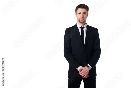 portrait of handsome agent in black suit looking at camera isolated on white