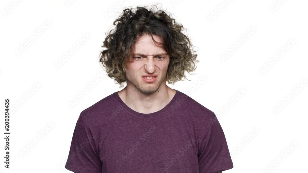 Portrait of caucasian guy sniffing and expressing disgust on his face due to bad smell, over white background. Concept of emotions Portrait of caucasian guy sniffing and expressing disgust on his face due to bad smell, over white background. Concept of emotions