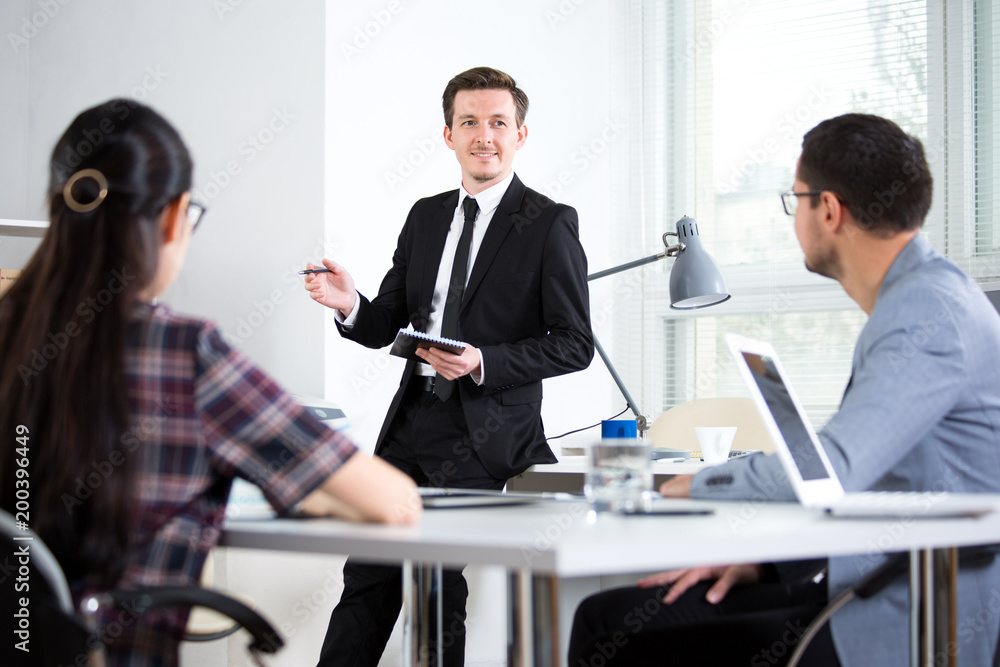 Businessman explains to businessmen a new project Businessman explains to businessmen a new project