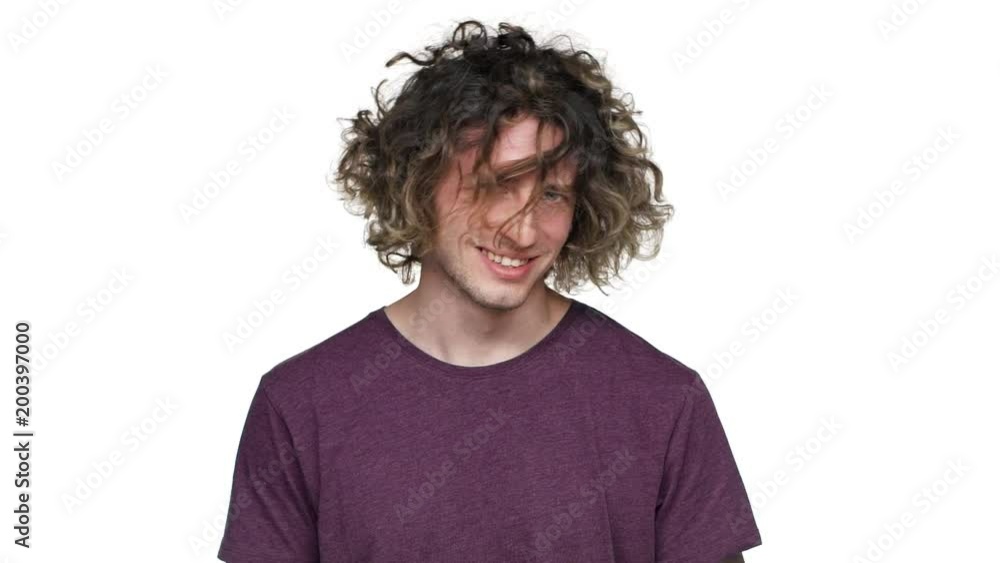Portrait of handsome hairy man in casual t-shirt smiling and shaking his curly hair, isolated over white background slow motion. Concept of emotions Portrait of handsome hairy man in casual t-shirt smiling and shaking his curly hair, isolated over white background slow motion. Concept of emotions