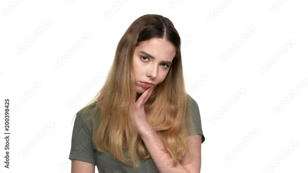 Portrait of thoughtful woman in casual t-shirt reflecting or doubting, isolated over white background closeup. Concept of emotions Portrait of thoughtful woman in casual t-shirt reflecting or doubting, isolated over white background closeup. Concept of emotions