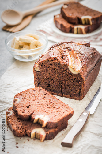 Chocolate banana bread on light concrete background. Selective focus ,space for text.