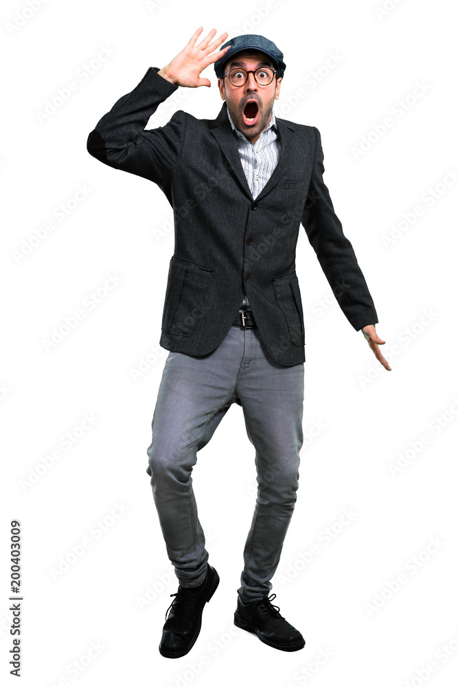 Handsome modern man with beret and glasses with surprise and shocked facial expression Handsome modern man with beret and glasses with surprise and shocked facial expression