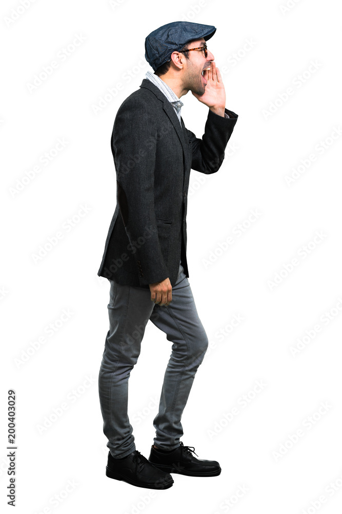 Handsome modern man with beret and glasses shouting with mouth wide open Handsome modern man with beret and glasses shouting with mouth wide open