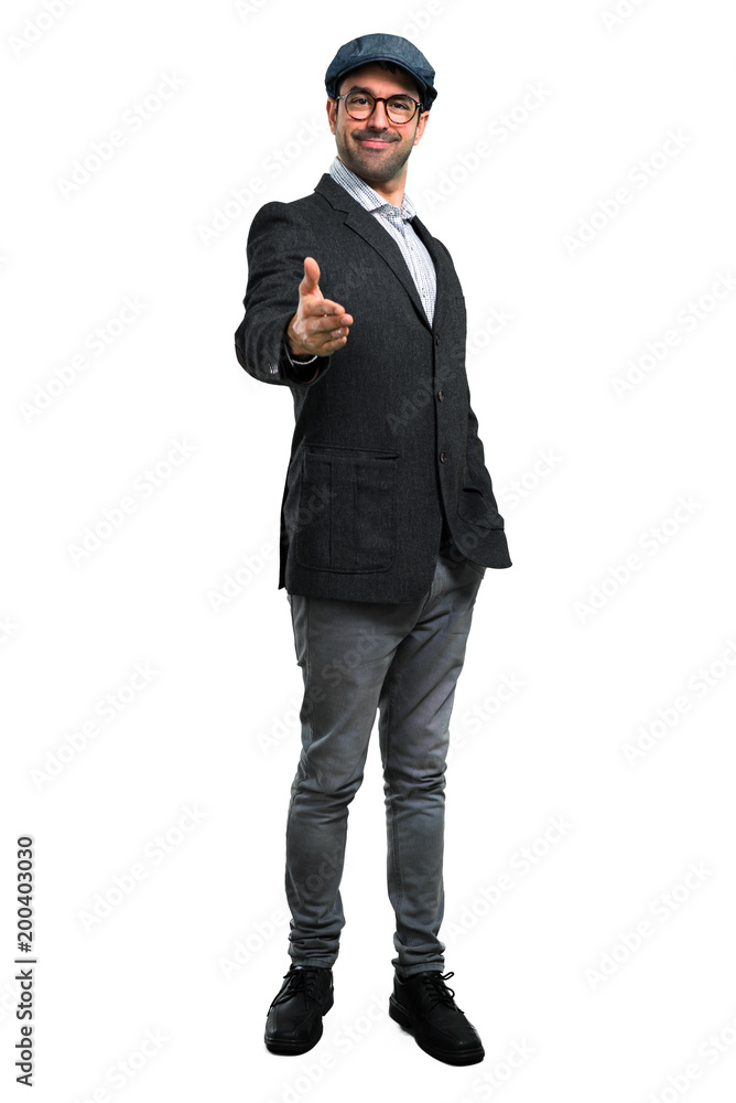 Handsome modern man with beret and glasses handshaking after good deal Handsome modern man with beret and glasses handshaking after good deal