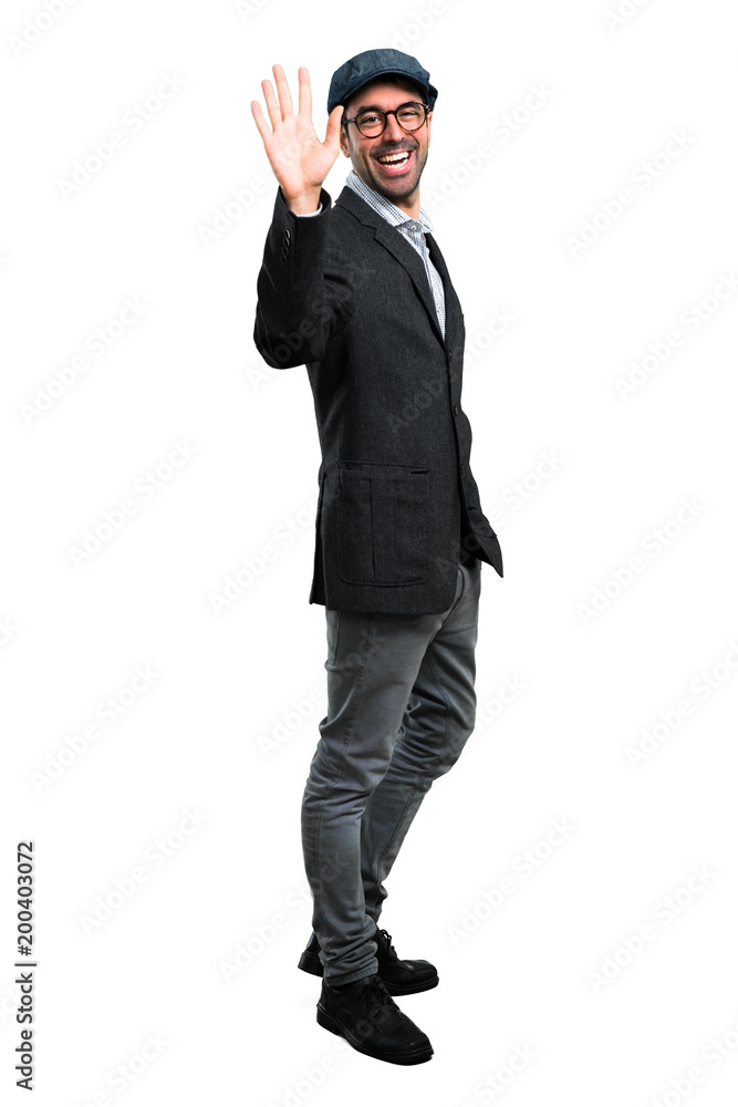 Handsome modern man with beret and glasses saluting Handsome modern man with beret and glasses saluting