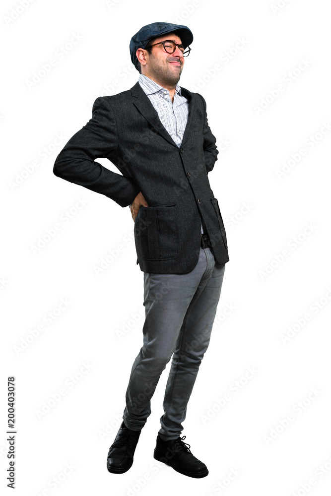 Handsome modern man with beret and glasses with back pain Handsome modern man with beret and glasses with back pain