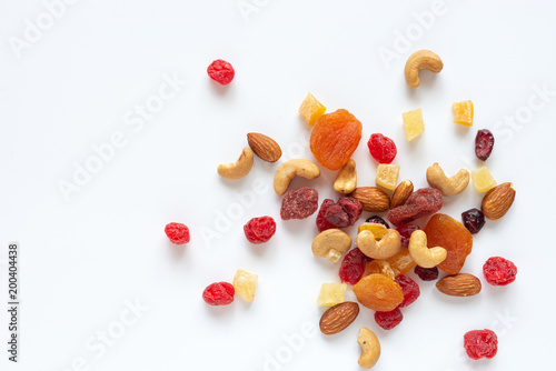Quadro em tela healthy snack: mixed nuts and dried fruits on white background from above, almond, pineapple, cranberry, papaya, apple, strawberry, cherry, apricot, casshew