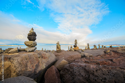 Series of stacked rock columns called cairns facing the sea in Reykjavik, Iceland. 