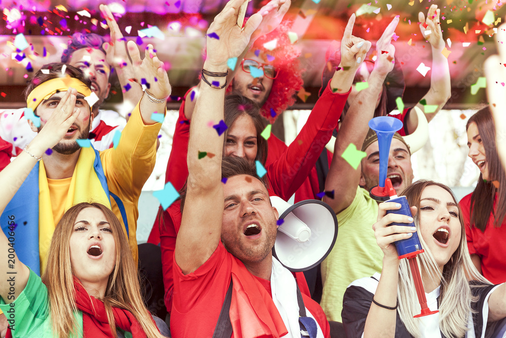 group of fans dressed in red color watching a sports event group of fans dressed in red color watching a sports event