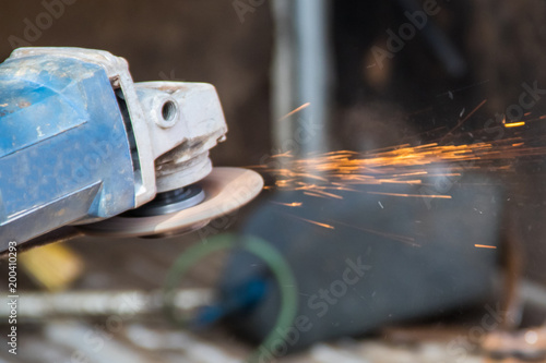 Cutting metal with angle grinder close-up