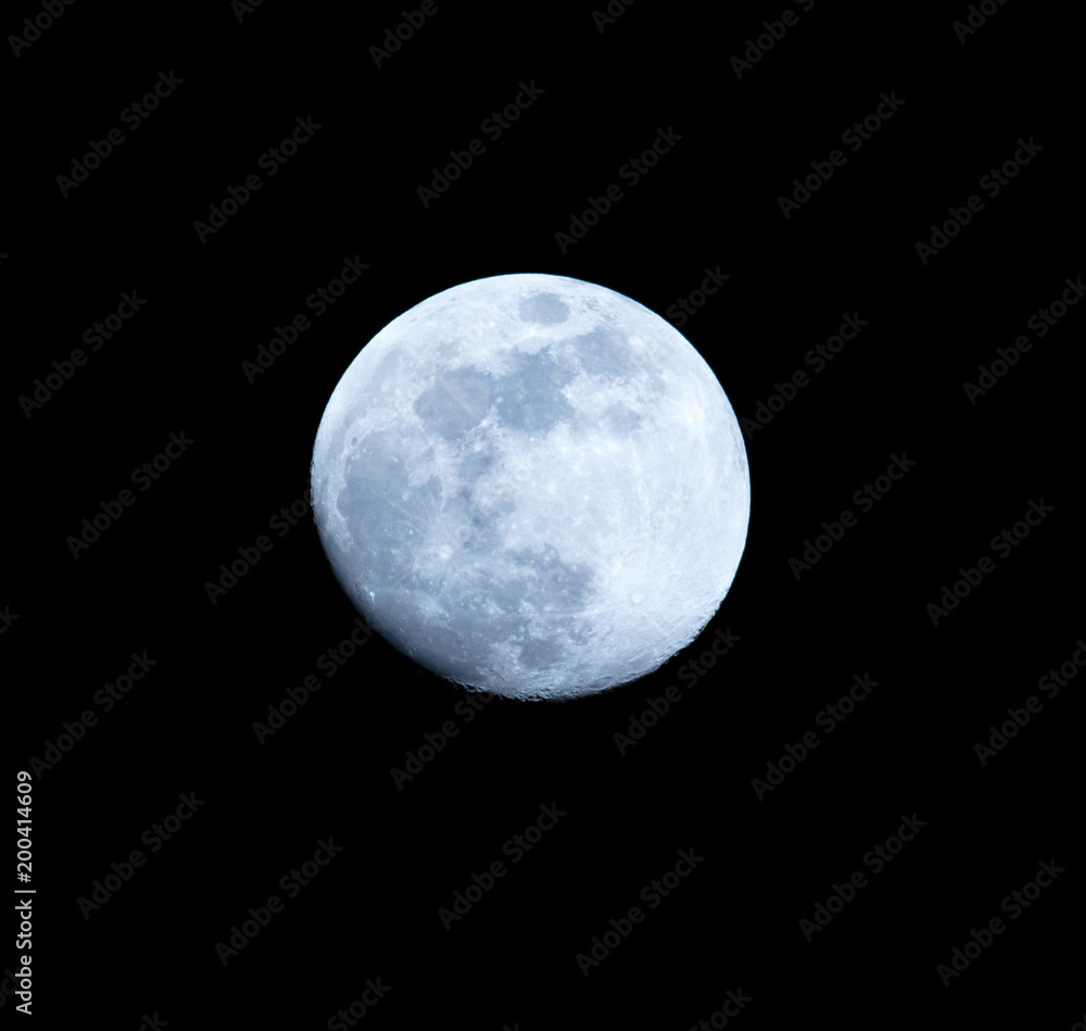 Blue moon on a black background at night Blue moon on a black background at night