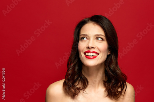 beauty, make up and people concept - happy smiling young woman with red lipstick