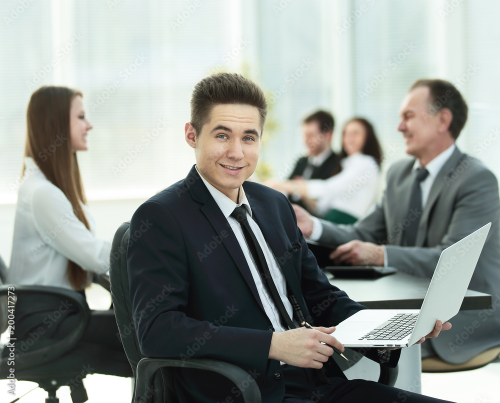 Portrait of handsome young business man and laptop Portrait of handsome young business man and laptop