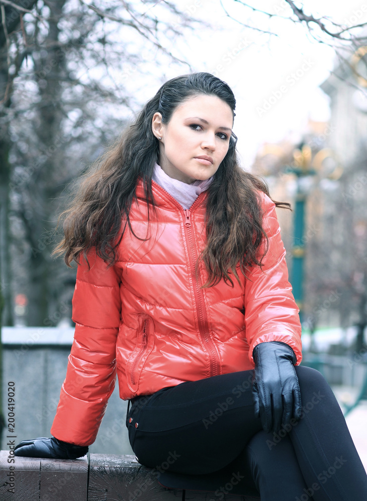 portrait of young woman on background of a winter city