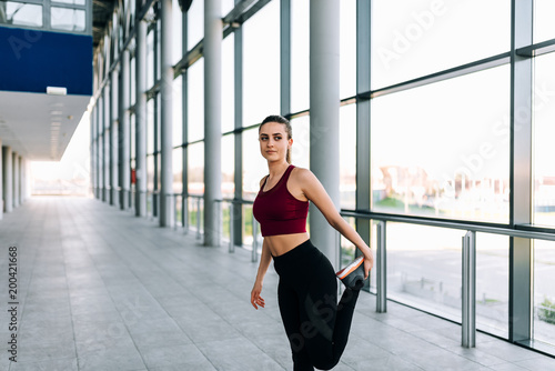 Free Download Portrait of young female runner stretching before run. - GFXLoad