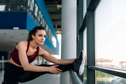 Free Download Portrait of gorgeous girl runner stretching before run. - GFXLoad