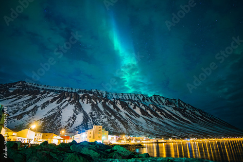 northern lights over the mountains and a cloudy sky