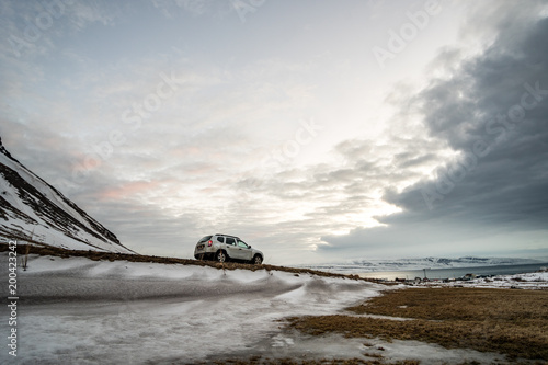 offroad car between snowy mountains