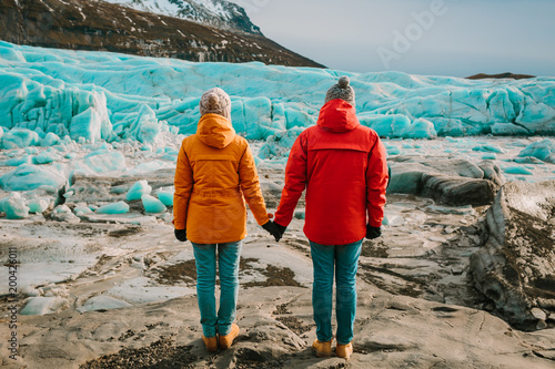 Traveling Man And Woman Exploring The Iceland Together. Ice Lagoon. Iceland traveling.