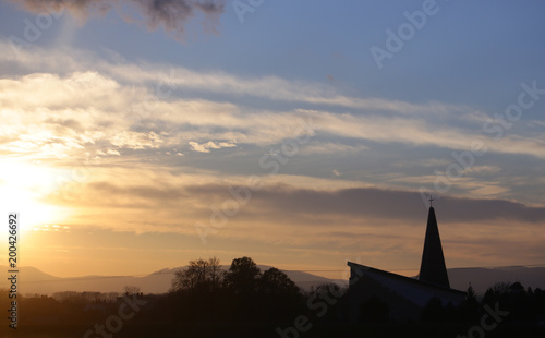 Landscape and church, cross silhouette on cloudy sunset sky © Volodymyr