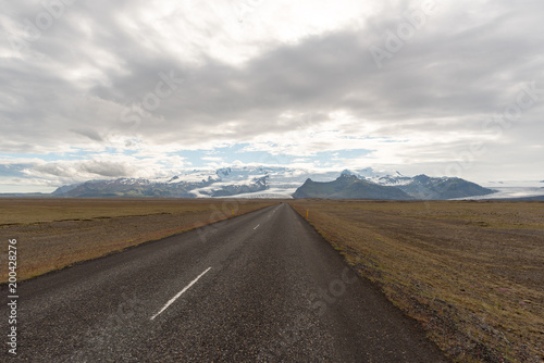 Travel to Iceland. Spectacular Icelandic landscape with road and scenic nature- fjords, fields, clouds. Driving the Ring Road in Southeast Iceland