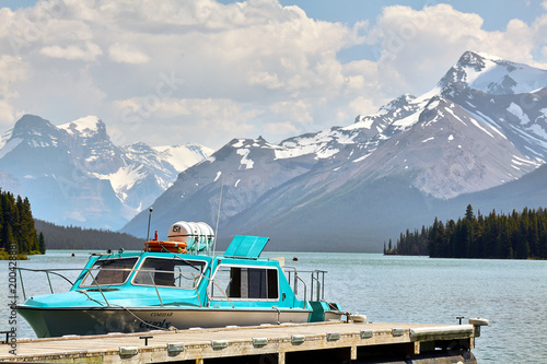 Relaxing Boat in Jasper Lake with Snowy mountains in the background