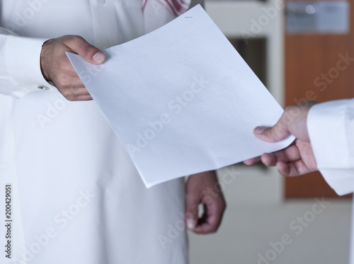 Photos Handing Over A Document