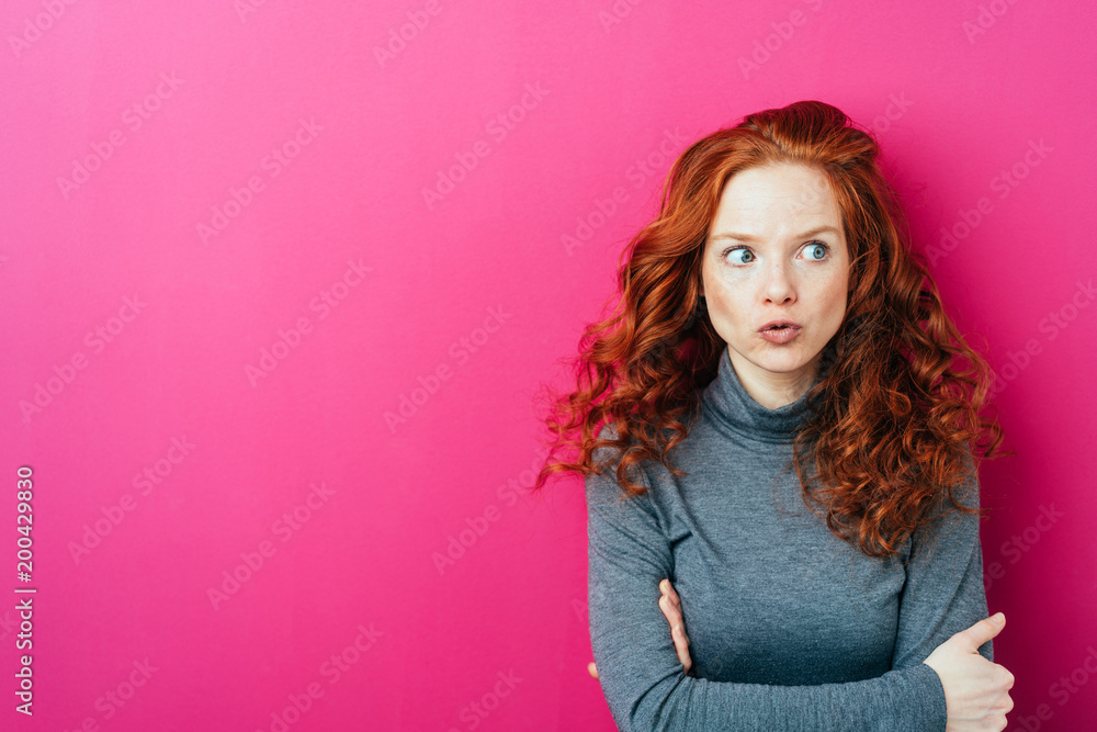 Young thoughtful woman against pink background Young thoughtful woman against pink background