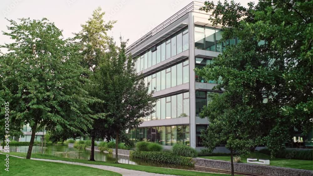 Modern office building in the city park. View of a business quarter on summer Modern office building in the city park. View of a business quarter on summer