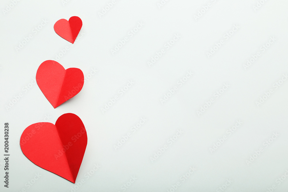 Red paper hearts on grey background