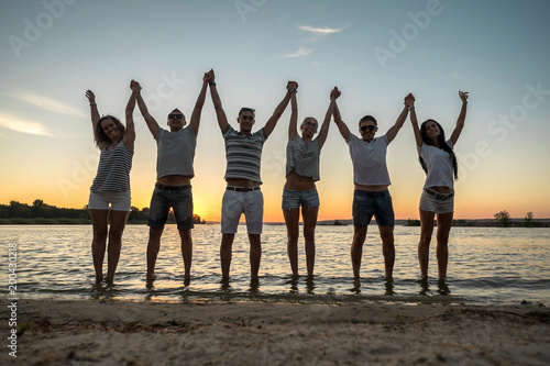 Silhouette of group young people on the beach.