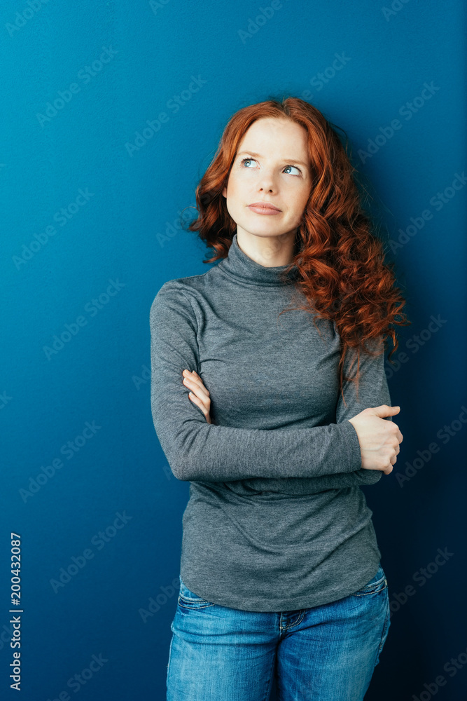 Thoughtful young red head woman looking up Thoughtful young red head woman looking up