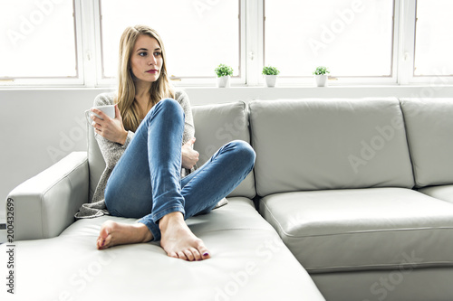 Young woman on a sofa on the living room Free Download Young woman on a sofa on the living room - GFXLoad