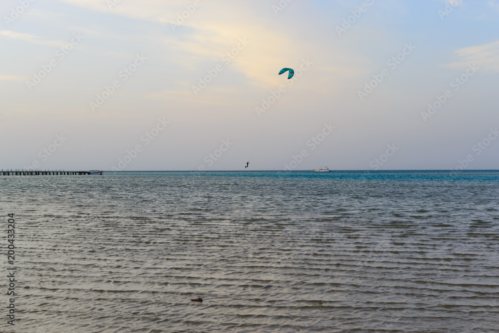 Kitesurfing silhouette on the horizon of the sea Kitesurfing silhouette on the horizon of the sea