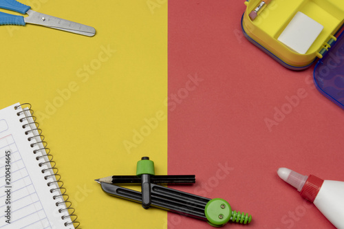 Back to school. Supplies on 2 color background photo