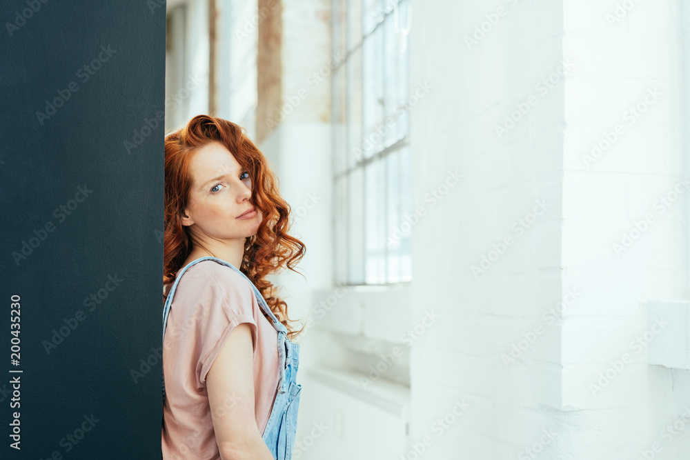 Fototapeta premium Thoughtful attractive young woman with red hair