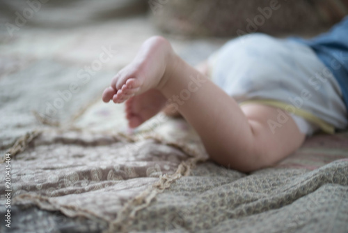 baby crawling on bed photo