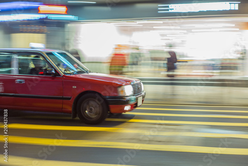 Red taxi rushing in the streest of Hong Kong at night with motion blur effect - 1