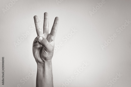 Hand showing three fingers.  photo