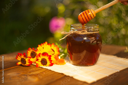 Delicious delicious honey in jar on table