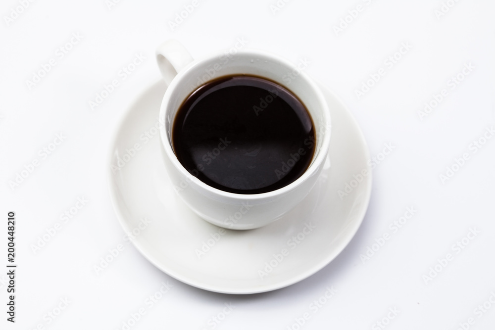 A cup of black coffee on a white 